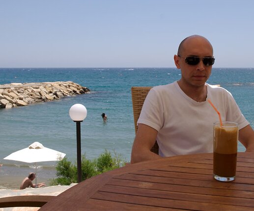 _DSC0004_1 Markos having a frappé at the open-air restaurant of the hotel.