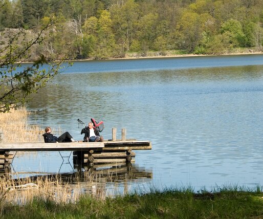 _DSC0013 People relaxing on a small pier by the lake.