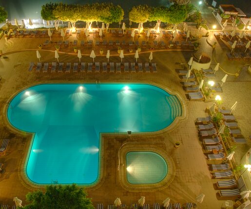Apollonia_HDR_1 Pool area at night, as seen from the room.