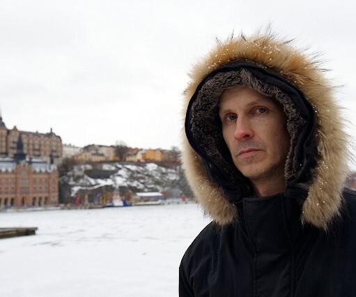 _DSC0032 Arto at Riddarholmen. The frozen waters of Riddarfjärden and the heights of Söder in the background.
