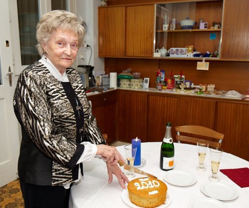 _DSC0012 Mum cutting the traditional Vasilopitta (New Year's cake).