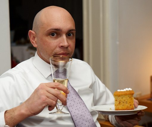 _DSC0028 Markos drinking Champagne and eating Vasilopitta.