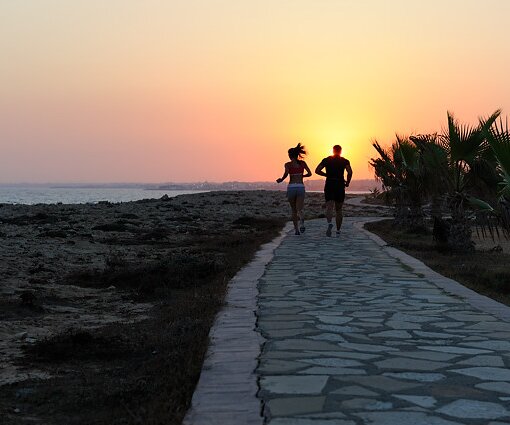 _DSC0077 Couple jogging towards the sunset in Protaras.