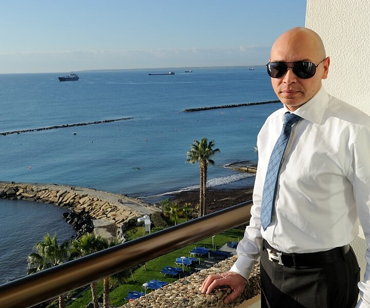 _DSC0006 Markos on the balcony of the hotel room at Crowne Plaza.