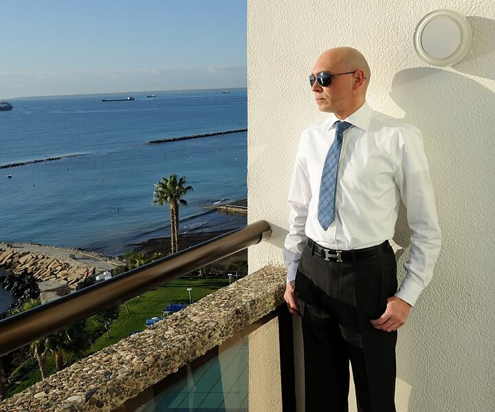 _DSC0008 Markos on the balcony of the hotel room at Crowne Plaza.