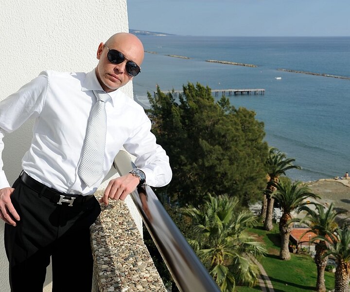 _DSC0079 Markos on the balcony of the hotel room at Crowne Plaza.