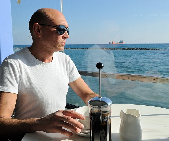 _DSC0005 Markos having coffee by the sea.