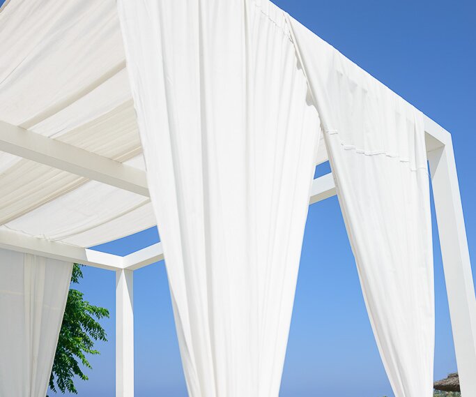 _DSC0020 At the loungers at Capo Bay Hotel . The clear blue waters of the Mediterranean at Fig Tree Bay in the background.