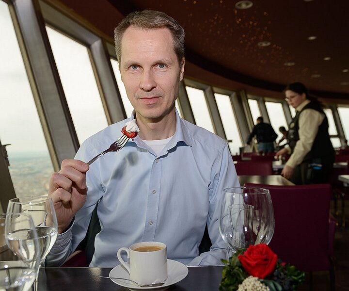 _DSC0097 Arto having dessert in the rotating restaurant Sphere in the TV-tower at Alexanderplatz. At a hight of 207 meters.