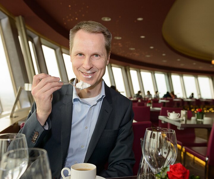 _DSC0102 Arto having dessert in the rotating restaurant Sphere in the TV-tower at Alexanderplatz. At a hight of 207 meters.