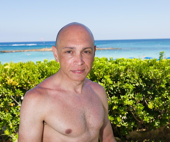 _DSC0010 Markos having coffee at the sunlounger at Capo Bay Hotel .