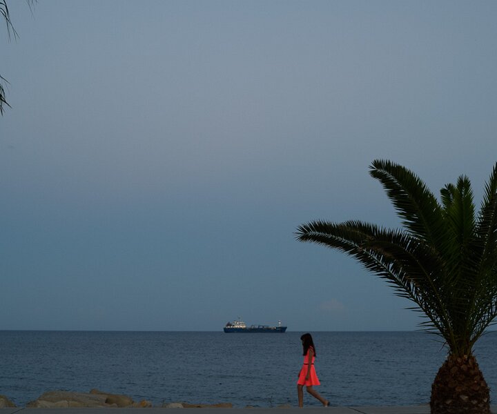 _DSC0168 Girl at the seaside promenade in Limassol at dusk.