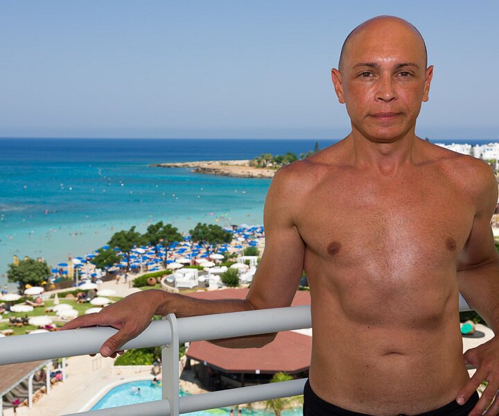 _DSC0104 Markos on the balcony of the room at Capo Bay hotel.