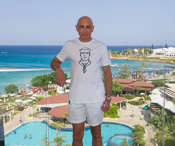 _DSC9318 Markos on the balcony of the room at Capo Bay hotel.