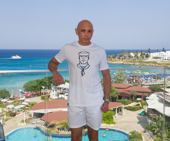 _DSC9321 Markos on the balcony of the room at Capo Bay hotel.