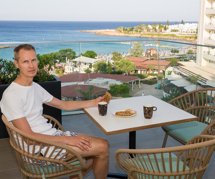 _DSC9362 Arto having coffee on the balcony at Capo Bay hotel.