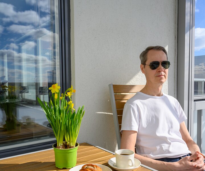 _DSC1578 Arto having morning coffee on the balcony and enjoying the first rays of sun in spring.